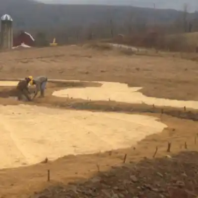 workers installing erosion control mat
