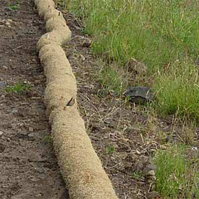 coir logs being installed on riverbank