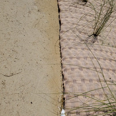 woven geotextile covered in sediment