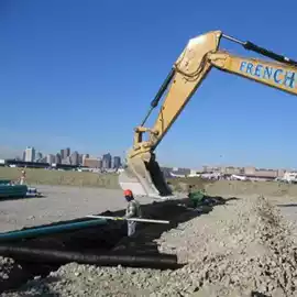 Man installing geotextile fabric on a construction site