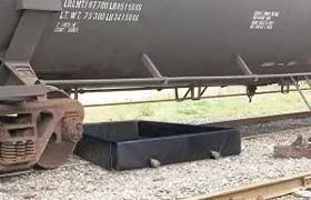 Spill containment berm installed underneath a train