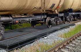 Composite track pan installed on a rail line