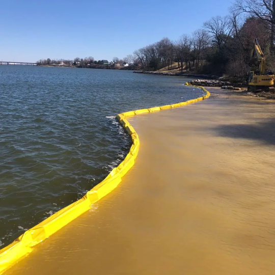 yellow turbidity barrier in river on job site