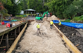 Temporary flood barriers installed on a boat ramp construction site